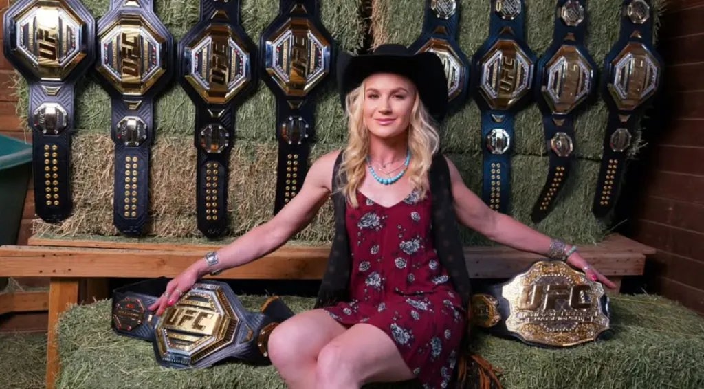 Female UFC fighter Valentina Shevchenko sitting down with ten championship belts