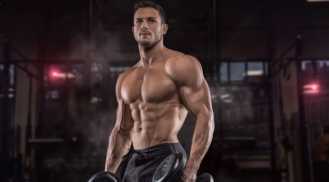 Young muscular athlete using a Science-Backed Dropset Strategy to build muscles