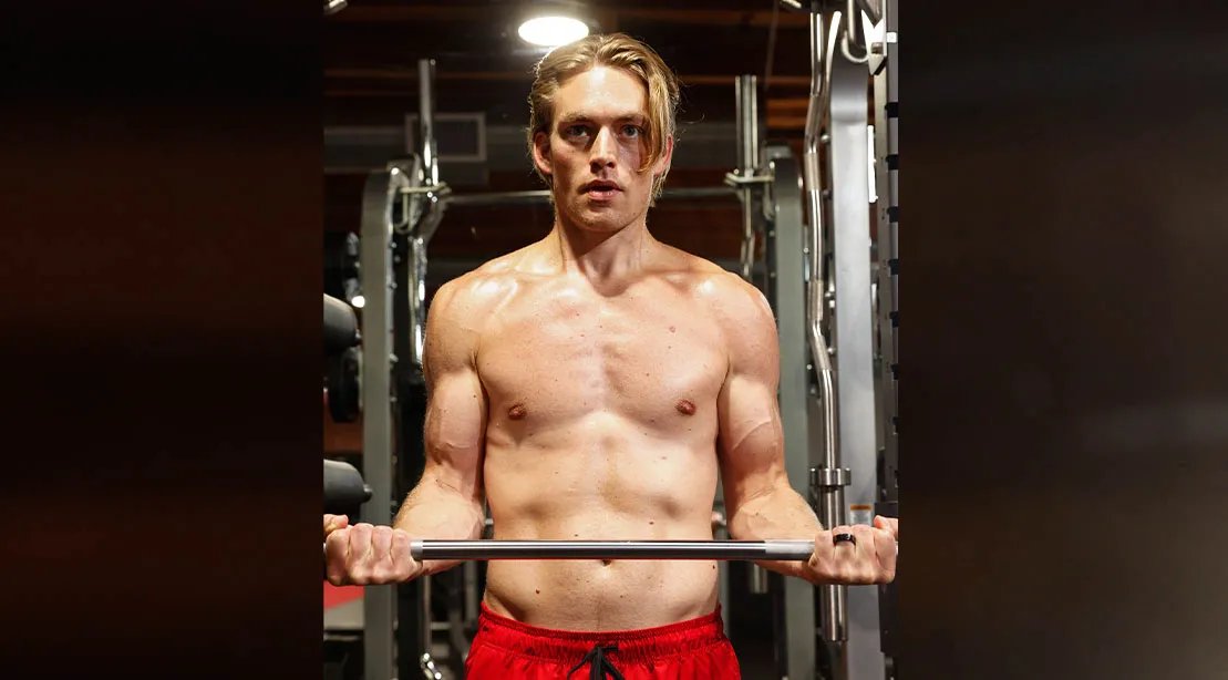 Actor and model Will Jardell performing barbell curls