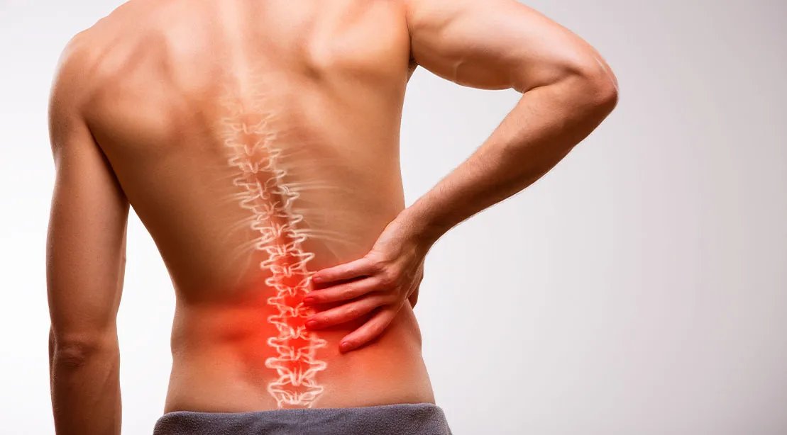 Anatomy of the lower back from a muscular man with lower back pain