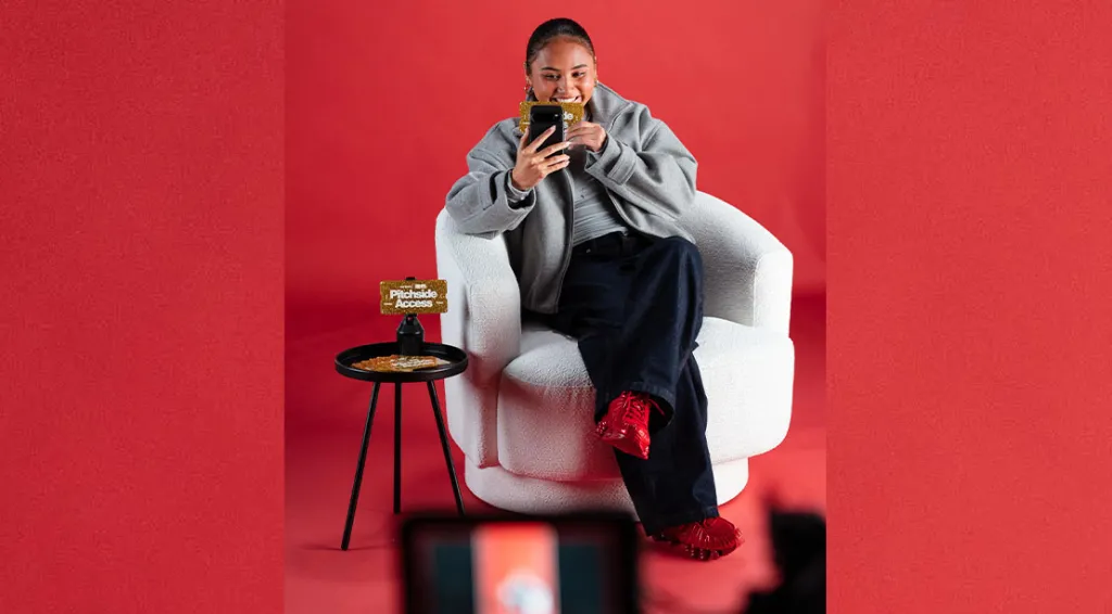 The Thompson sisters Alyssa & Gisele Thompson players at the Women's Fifa Soccer Team looking at her phone on a red couch
