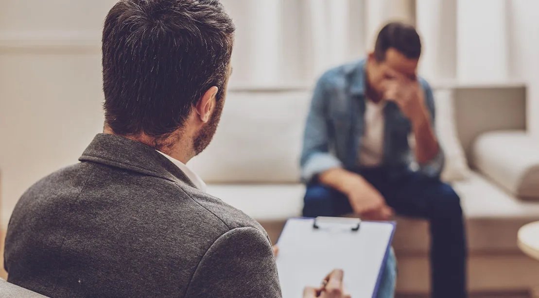 Young man in a therapy session to heal trauma and mental health purposes