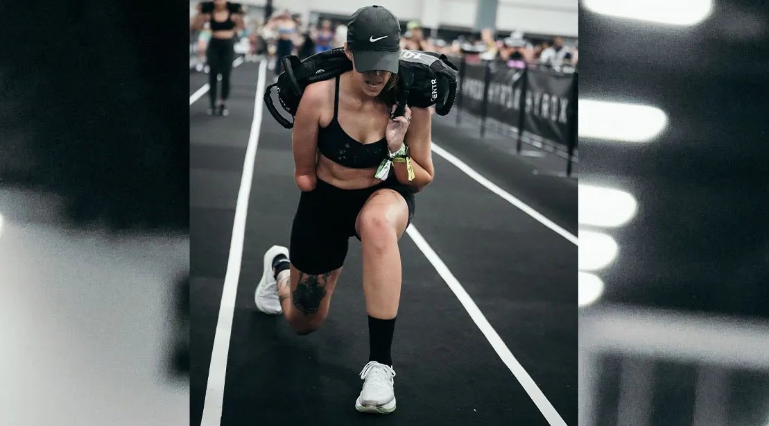 Katie Thomas performing sandbag carry at the 2026 HYROX competition